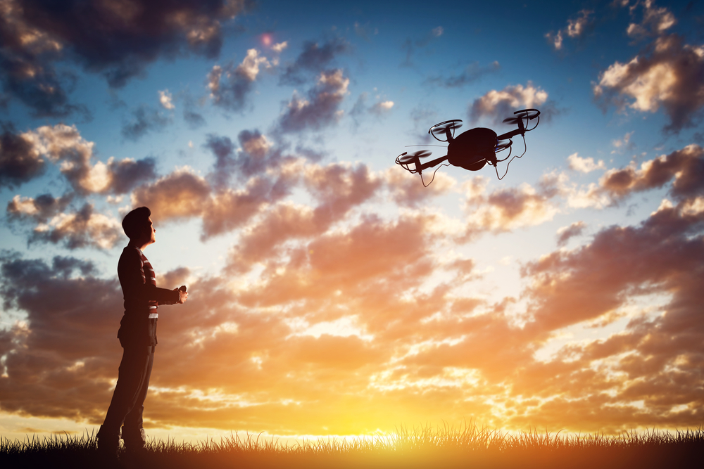 Man,Operating,A,Drone,At,Sunset,Using,A,Controller.,3d